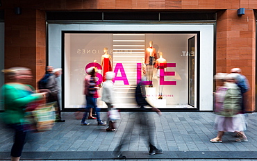 The movement of shoppers at Liverpool One shopping centre in front of a shop with a sale on, Liverpool, Merseyside, England, United Kingdom, Europe