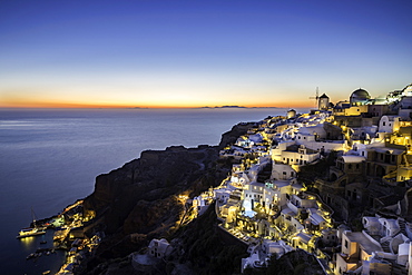 Long exposure sunset view over the whitewashed buildings and windmills of Oia, Santorini, Cyclades, Greek Islands, Greece, Europe