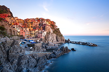 Beautiful sunset light shines on the colourful town of Manarola during a long exposure, Manarola, Cinque Terre, UNESCO World Heritage Site, Liguria, Italy, Europe