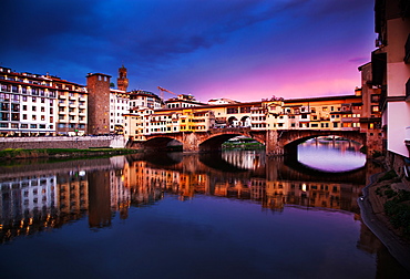 Ponte Vecchio at sunset reflecting in River Arno, Florence, UNESCO World Heritage Site, Tuscany, Italy, Europe