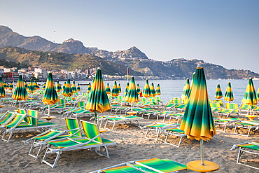 empty beach with chairs and umbrellas