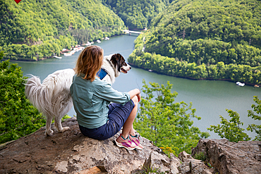 woman overlooking Tarnita lake bright green summer landscape