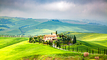 Farmhouse in green summer landscape near Crete Senesi, Tuscany, Italy, Europe