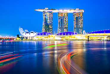 SINGAPORE, SINGAPORE - MARCH 2019: Skyline of Singapore Marina Bay at night with Marina Bay sands, Art Science museum and tourist boats