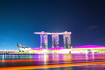 SINGAPORE, SINGAPORE - MARCH 2019: Skyline of Singapore Marina Bay at night with Marina Bay sands, Art Science museum and tourist boats