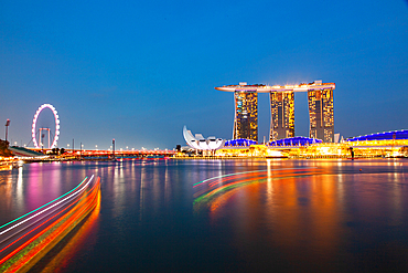 SINGAPORE, SINGAPORE - MARCH 2019: Skyline of Singapore Marina Bay at night with Marina Bay sands, Art Science museum and tourist boats