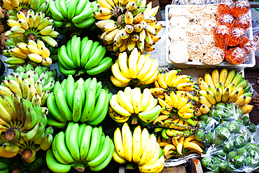 floating market - top view of boat full of fresh fruits on sale