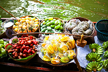 floating market - top view of boat full of fresh fruits on sale