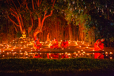 Makha bucha day celebrations in Chiangmai.Traditional monks pray under illuminated Buddha statue annually at Wat Phan Tao temple in Chiangmai,Thailand