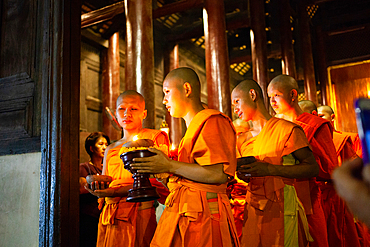 Makha bucha day celebrations in Chiangmai.Traditional monks pray under illuminated Buddha statue annually at Wat Phan Tao temple in Chiangmai,Thailand