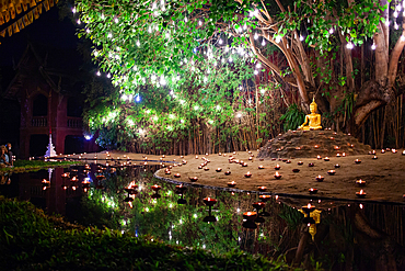 Makha bucha day celebrations in Chiangmai.Traditional monks pray under illuminated Buddha statue annually at Wat Phan Tao temple in Chiangmai,Thailand