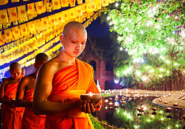 Makha bucha day celebrations in Chiangmai.Traditional monks pray under illuminated Buddha statue annually at Wat Phan Tao temple in Chiangmai,Thailand