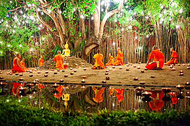 Makha bucha day celebrations in Chiangmai.Traditional monks pray under illuminated Buddha statue annually at Wat Phan Tao temple in Chiangmai,Thailand