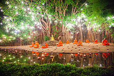 Makha bucha day celebrations in Chiangmai.Traditional monks pray under illuminated Buddha statue annually at Wat Phan Tao temple in Chiangmai,Thailand