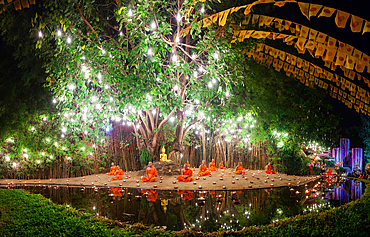 Makha bucha day celebrations in Chiangmai.Traditional monks pray under illuminated Buddha statue annually at Wat Phan Tao temple in Chiangmai,Thailand