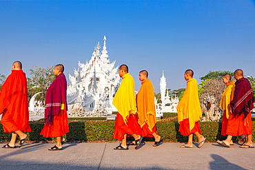 Buddhist monks at wat Rong Khun The famous White Temple in Chiang Rai, Thailand