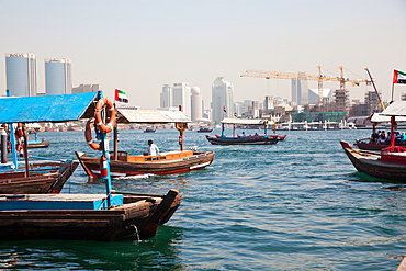 Traditional Abra ferries crossing Dubai Creek. The Creek divides the city into two main sections: Deira and Bur Dubai