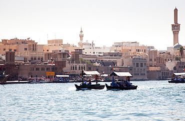 Traditional Abra ferries crossing Dubai Creek. The Creek divides the city into two main sections: Deira and Bur Dubai