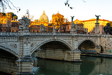 Sunrise hits the Vatican and St. Peter's Basilica but has not reached Vittorio Emanuele II bridge in the foreground, Rome, Lazio, Italy, Europe