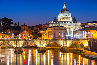 Illuminated St. Peters Basilica and the Vatican with Ponte St Angelo over the River Tiber at dusk, Rome, Lazio, Italy, Europe