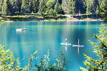 Young couple practise stand up paddling, Caumasee, Flims, District of Imboden, Canton of Grisons (Graubunden), Switzerland, Europe