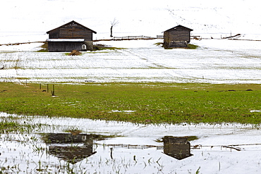 Typical Walser houses reflected in pond, Versam, Safiental, Surselva, Graubunden, Switzerland, Europe