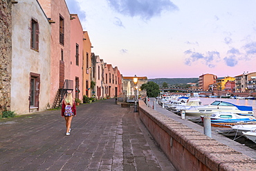 A girl walks at sunrise, Bosa, Oristano province, Sardinia, Italy, Mediterranean, Europe