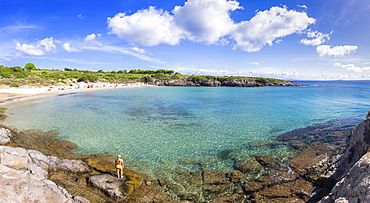 Girl in swimsuit looks at the beach, La Bobba Beach, San Pietro Island, Sud Sardegna province, Sardinia, Italy, Mediterranean, Europe