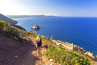 A girl walks on a path to Laveria Lamarmora, Nebida, Iglesias, Sud Sardegna province, Sardinia, Italy, Mediterranean, Europe