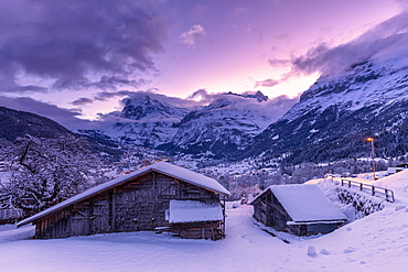 Traditional hut at sunrise after a snowfall, Grindelwald, Canton of Bern, Switzerland, Europe