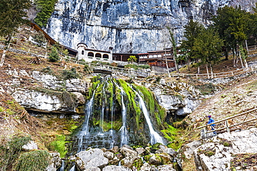 Tourist looking at St. Beatus Waterfall, Beatenberg, Canton of Bern, Switzerland, Europe