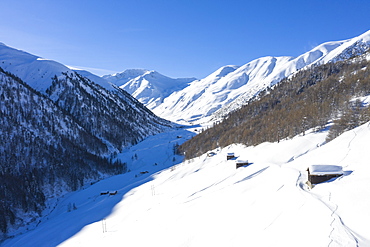 Aerial view of traditional huts in winter, Val Federia, Livigno, Valtellina, Lombardy, Italy, Europe