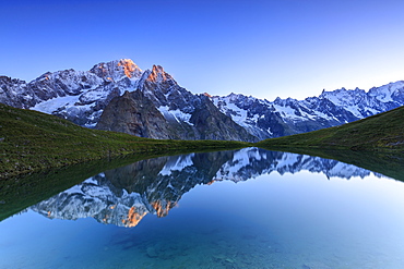 Mont Blanc reflected in Lac Checrouit (Checrouit Lake) at sunrise, Veny Valley, Courmayeur, Aosta Valley, Italy, Europe