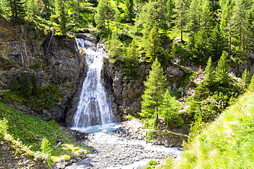 Waterfall of Val Nera with tourist on the path, Livigno, Valtellina, Lombardy, Italy, Europe