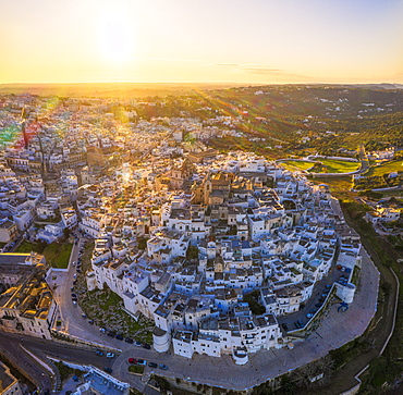 Aerial view by drone of the old town of Ostuni at sunset, Apulia, Italy, Europe