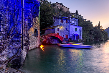 Boat in motion under the illuminated Nesso bridge, Lake Como, Lombardy, Italian Lakes, Italy, Europe