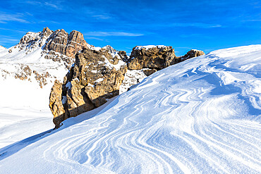 One person and natural rock arch with snow shaped by the wind in the foreground, Julier Pass, Graubunden, Switzerland, Europe