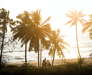 Tourist on a moped at sunset, Varkala, Kerala, India, Asia