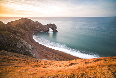 Durdle Door at sunrise, Lulworth Cove, Jurassic Coast, UNESCO World Heritage Site, Dorset, England, United Kingdom, Europe