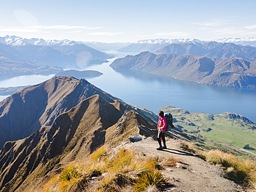 Woman hiker enjoying the view from the Roys Peak trail near Wanaka, Otago, South Island, New Zealand, Pacific