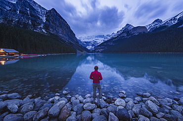 Lone traveler at Lake Louise in the morning, Banff National Park, UNESCO World Heritage Site, Canadian Rockies, Alberta, Canada, North America