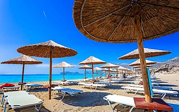 Umbrellas on the beach and emerald seas at Falassarna beach in Western Crete, Greek Islands, Greece, Europe