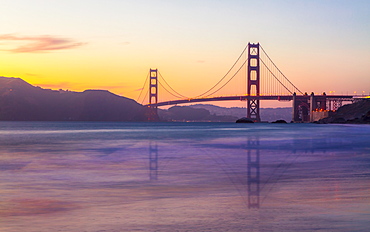 Soft flowing water reflects the beautiful Golden Gate Bridge at sunset, San Francisco, California, United States of America, North America