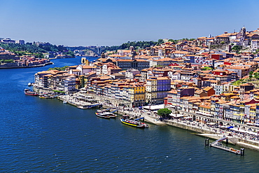 The Douro River banks with waterfront houses and boats seen from Dom Luis I Bridge, Porto, Portugal, Europe