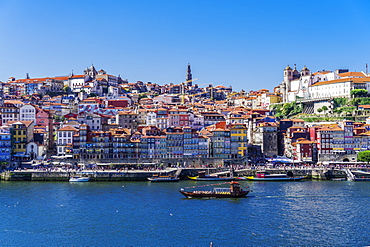 Boats on the Douro River and traditional houses of Ribeira District seen from Vila Nova de Gaia district, Porto, Portugal, Europe