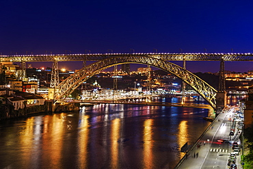 Night view of Dom Luis I Bridge over Douro River with Vila Nova de Gaia with traditional buildings in the background, Porto, Portugal, Europe