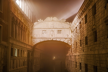 Foggy view without crowd of Ponte de Sospiri, iconic Bridge of Sighs stone bridge at night, Venice, UNESCO World Heritage Site, Veneto, Italy, Europe