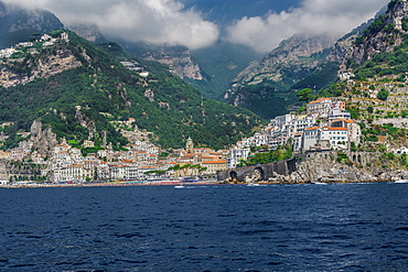 Amalfi Town, landscape sea view with low rise buildings and cliffs along the coastline in Costiera Amalfitana, UNESCO World Heritage Site, Campania, Italy, Europe