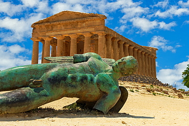 Temple of Concordia with statue, ancient Greek Doric temple with Fallen Icarus bronze statue in Valley of the Temples, Agrigento, UNESCO World Heritage Site, Sicily, Italy, Europe