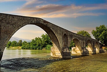 Day view of historic stone bridge of Arta above the Arachthos River, Arta, Epirus region, Greece, Europe